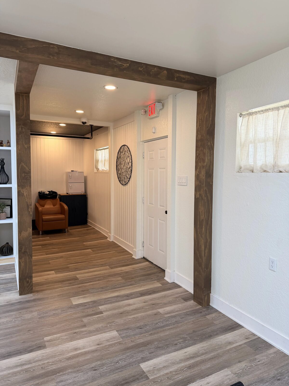 Natural wood beams framing a quiet passage through One Refined Heritage